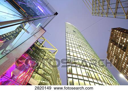 Stock Photo - Low angle view of skyscrapers lit up at dusk, Potsdamer Platz, Berlin, Germany . Fotosearch
