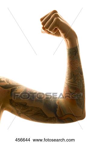 Man flexing his tattooed muscles View Large Photo Image Picture - Man flexing his tattooed muscles . Fotosearch