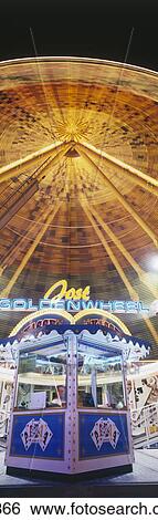 Stock Photograph - Merry-go-round lit up at night . Fotosearch