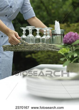 Mid section view of woman holding tray of glasses View Large Photo Image Stock Photo - Mid section view of woman holding tray of glasses . Fotosearch