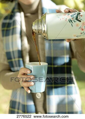 Mid section view of woman pouring coffee in cup View Large Photo Image Stock Image - Mid section view of woman pouring coffee in cup . Fotosearch