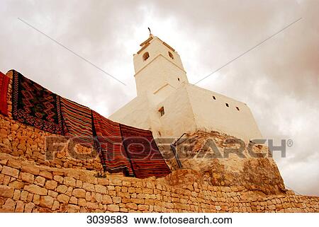 Stock Image - Minaret at the tunisian desert town of Chenini, view from below . Fotosearch