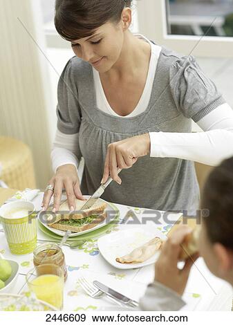 Mother and daughter having breakfast View Large Photo Image Stock Photo - Mother and daughter having breakfast . Fotosearch