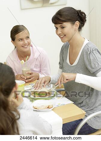 Picture - Mother and daughters having breakfast . Fotosearch