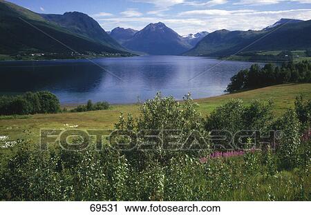 Stock Image - Mountain range near lake, Norway . Fotosearch