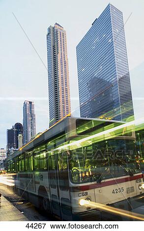 Stock Photo - Moving bus in city, Water Tower Place, Chicago, Illinois, USA . Fotosearch