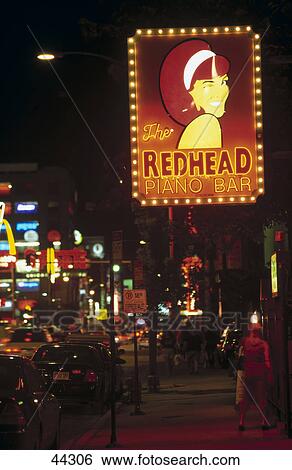 Stock Photograph - Neon sign of bar glowing at night, Redhead Piano Bar, Chicago, Illinois, USA . Fotosearch