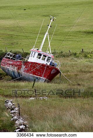 Picture - Old fishing boat on a field, Killybegs, Ireland . Fotosearch
