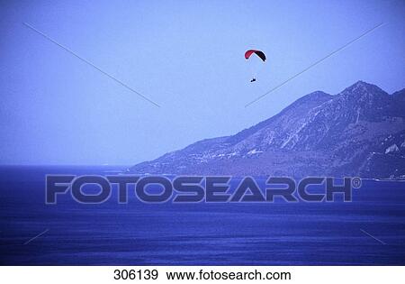 Stock Photo - Paraglider over sea, Greece . Fotosearch