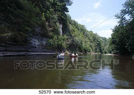 Stock Image - People boating in ravine, Upper Iowa River, Winneshiek County, Iowa, USA . Fotosearch