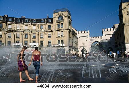 Picture - People enjoying near fountain at town square, Karlsplatz, Munich, Bavaria, Germany . Fotosearch