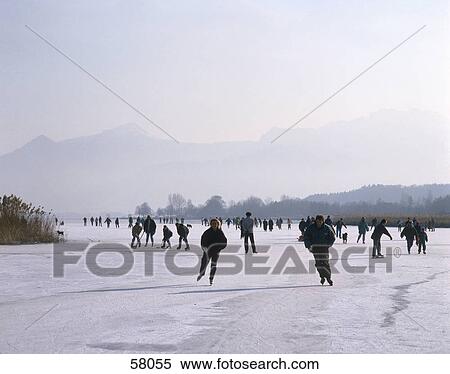 Stock Photography - People ice skating, Schafwaschener, Chiemsee Lake, Upper Bavaria, Bavaria, Germany . Fotosearch