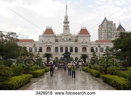 Stock Photo - People in front of statue of Ho Chi Minh and city hall, Ho Chi Minh City, Vietnam . Fotosearch