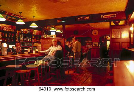 Stock Image - People in pub at night, Spiddal, Galway Bay, County Galway, Republic Of Ireland . Fotosearch
