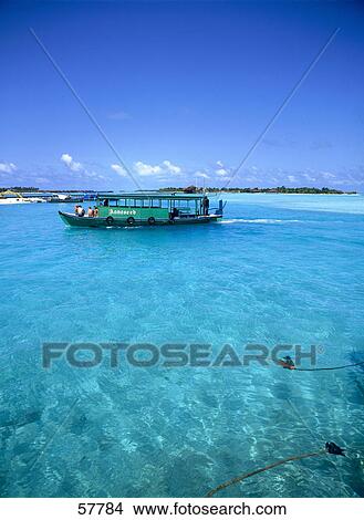 Picture - People on a tour boat in the sea, Dhigufinolhu, Maldives . Fotosearch