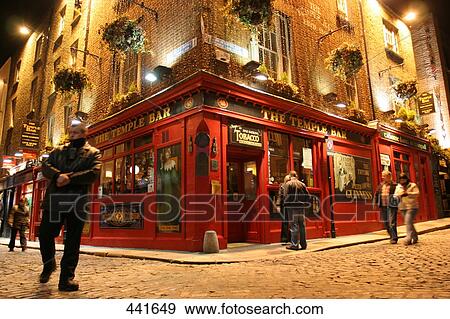 People walking in front of bar lit up at night, Dublin, Republic of Ireland View Large Photo Image Stock Photo - People walking in front of bar lit up at night, Dublin, Republic of Ireland . Fotosearch