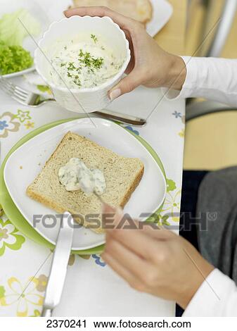 Person's hands spreading cream cheese on slice of bread View Large Photo Image Stock Image - Person's hands spreading cream cheese on slice of bread . Fotosearch