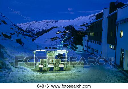 Stock Photograph - Petrol pump in village lit up at night, Obergural, Oetztal Alps, Tyrol, Austria . Fotosearch