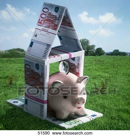 Stock Image - Piggy bank with model house in meadow . Fotosearch