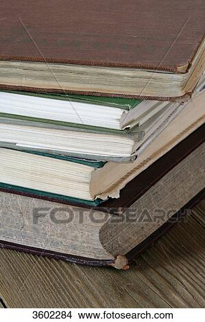 Pile of old books on wooden table, close-up View Large Photo Image Picture - Pile of old books on wooden table, close-up . Fotosearch