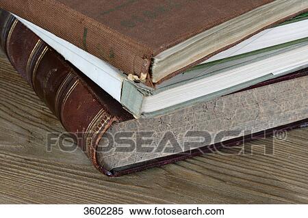 Pile of old books on wooden table, close-up View Large Photo Image Stock Photography - Pile of old books on wooden table, close-up . Fotosearch