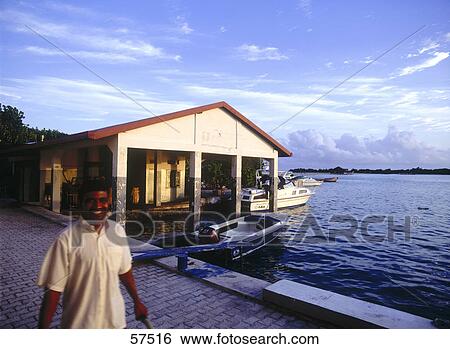 Stock Photograph - Portrait of a person near the sea, Maldives . Fotosearch