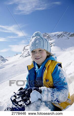 Portrait of boy smiling on snowcovered landscape View Large Photo Image Stock Photograph - Portrait of boy smiling on snowcovered landscape . Fotosearch