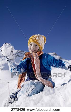 Portrait of boy throwing snowball and smiling on snowcovered landscape View Large Photo Image Stock Photograph - Portrait of boy throwing snowball and smiling on snowcovered landscape . Fotosearch