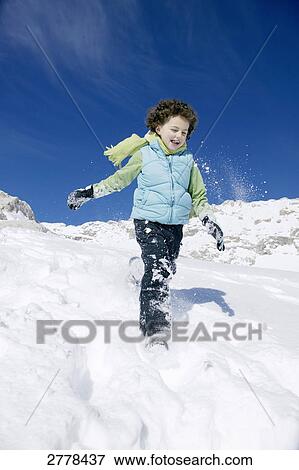 Portrait of boy walking on snowcovered landscape View Large Photo Image Stock Photo - Portrait of boy walking on snowcovered landscape . Fotosearch