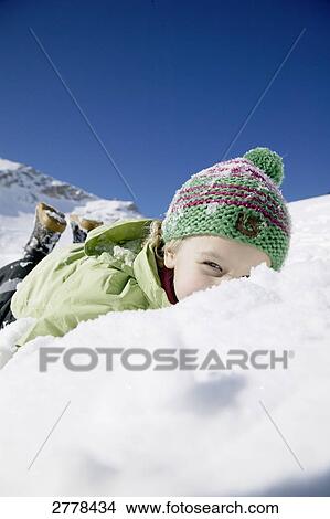 Portrait of girl lying on snow View Large Photo Image Picture - Portrait of girl lying on snow . Fotosearch