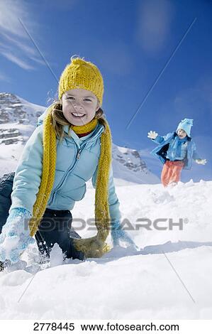 Stock Photography - Portrait of girl smiling on snowcovered landscape . Fotosearch