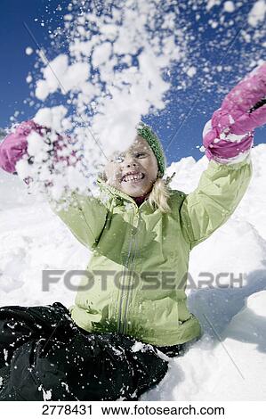 Portrait of girl throwing snow and smiling View Large Photo Image Stock Image - Portrait of girl throwing snow and smiling . Fotosearch