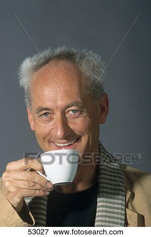 Stock Photo - Portrait of man drinking cup of tea . Fotosearch