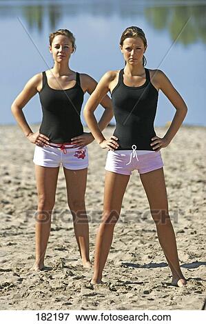 Portrait of two young women doing yoga on lake beach View Large Photo Image Stock Photo - Portrait of two young women doing yoga on lake beach . Fotosearch