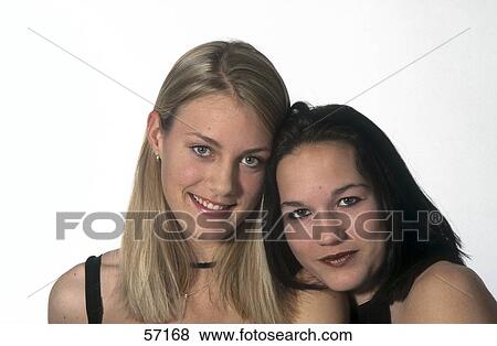 Stock Photo - Portrait of two young women smiling . Fotosearch
