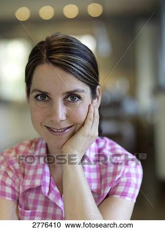 Stock Image - Portrait of woman smiling . Fotosearch