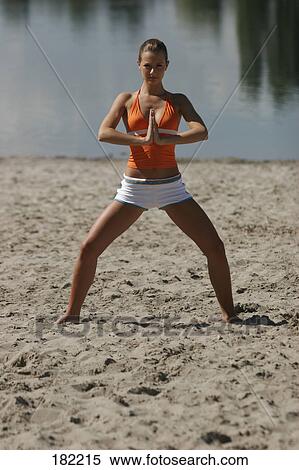 Portrait of young woman doing yoga on lake beach View Large Photo Image Stock Photography - Portrait of young woman doing yoga on lake beach . Fotosearch