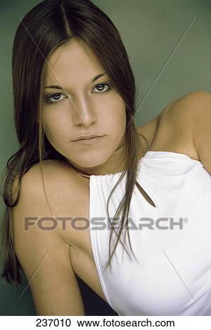 Stock Image - Portrait of young woman looking serious . Fotosearch