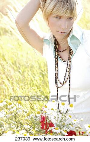 Portrait of young woman looking serious in field View Large Photo Image Stock Photo - Portrait of young woman looking serious in field . Fotosearch