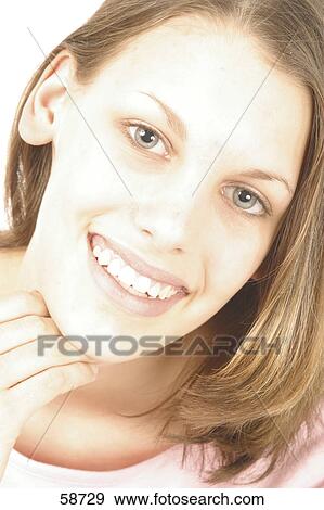 Stock Photo - Portrait of young woman smiling . Fotosearch