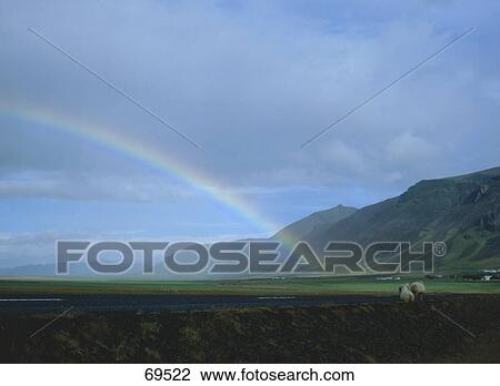 Stock Image - Rainbow over landscape, Kvisker, Iceland . Fotosearch