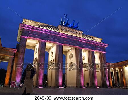 Stock Photo - Rear view of woman taking picture of gate, Brandenburg Gate, Berlin, Germany . Fotosearch