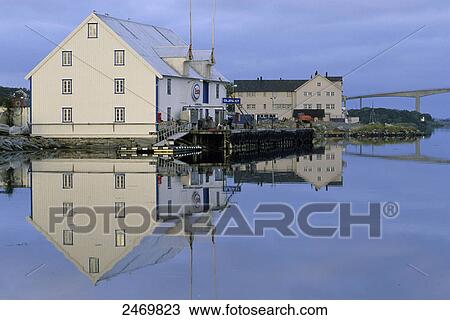 Stock Image - Reflection of houses in water, Harmfjord, Bronnoysund, Norway . Fotosearch
