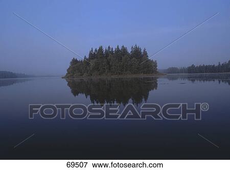 Reflection of trees in lake, Smaland, Sweden View Large Photo Image Stock Photo - Reflection of trees in lake, Smaland, Sweden . Fotosearch