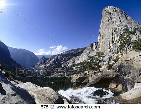 Stock Image - River flowing through rocks, El Capitan peak, Yosemite National Park, California, USA . Fotosearch