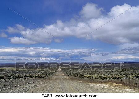 Stock Image - Road passing through arid landscape, Patagonia, Argentina . Fotosearch