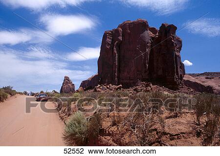 Stock Image - Road passing through desert, Spearhead Mesa, Monument Valley, Arizona, USA . Fotosearch