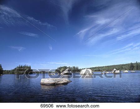 Stock Photograph - Rocks in lake, Smaland, Sweden . Fotosearch