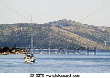 Sailing boat in front of the Dalmatian coast, Trogir, Croatia View Large Photo Image Stock Image - Sailing boat in front of the Dalmatian coast, Trogir, Croatia . Fotosearch