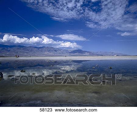 Stock Image - Salt lake near a mountain, Badwater, Death Valley National Park, Death Valley, California, USA . Fotosearch